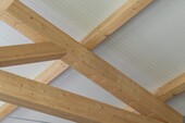 Close-up view of the internal truss structure of the timber frame